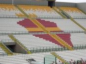 Uno scorcio dello stadio del Messina con il logo disegnato sui seggiolini