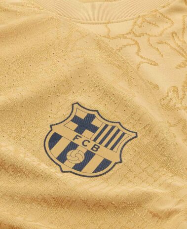 Lo stemma monocolore del Barcellona sulla divisa dorata